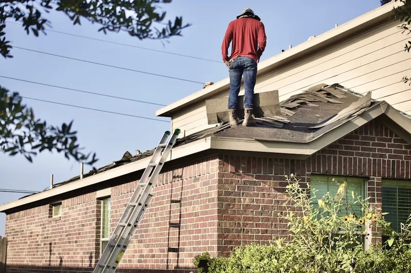 Professional roofer working on a residential roof in Fillmore